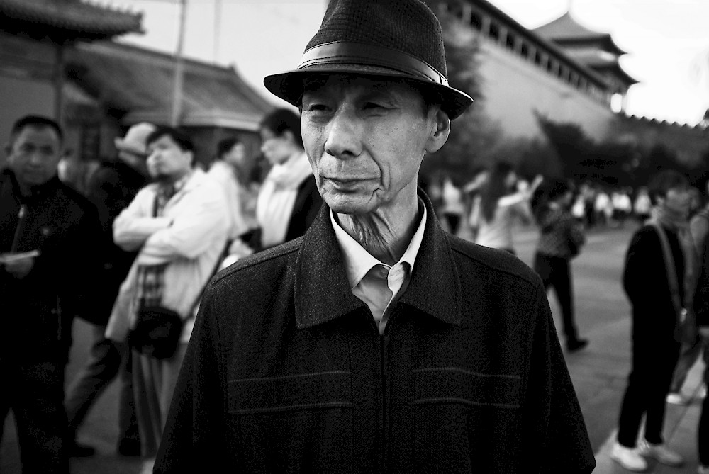 An old men in front of the forbidden city