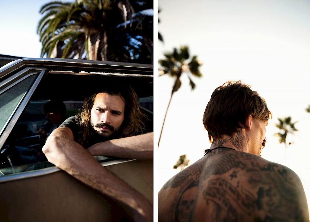 two pictures of guys in evening, the one, tattooed, is walking towards the sunset with palm trees in the background, the other one with longer hair is looking out of the window of his Impala SS