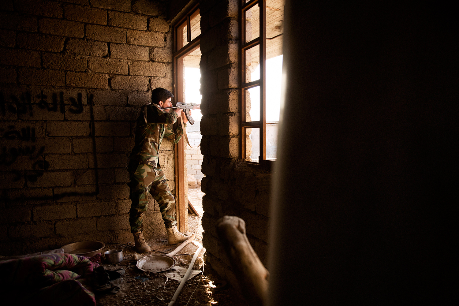 A Peshmerga fighter with his weapon