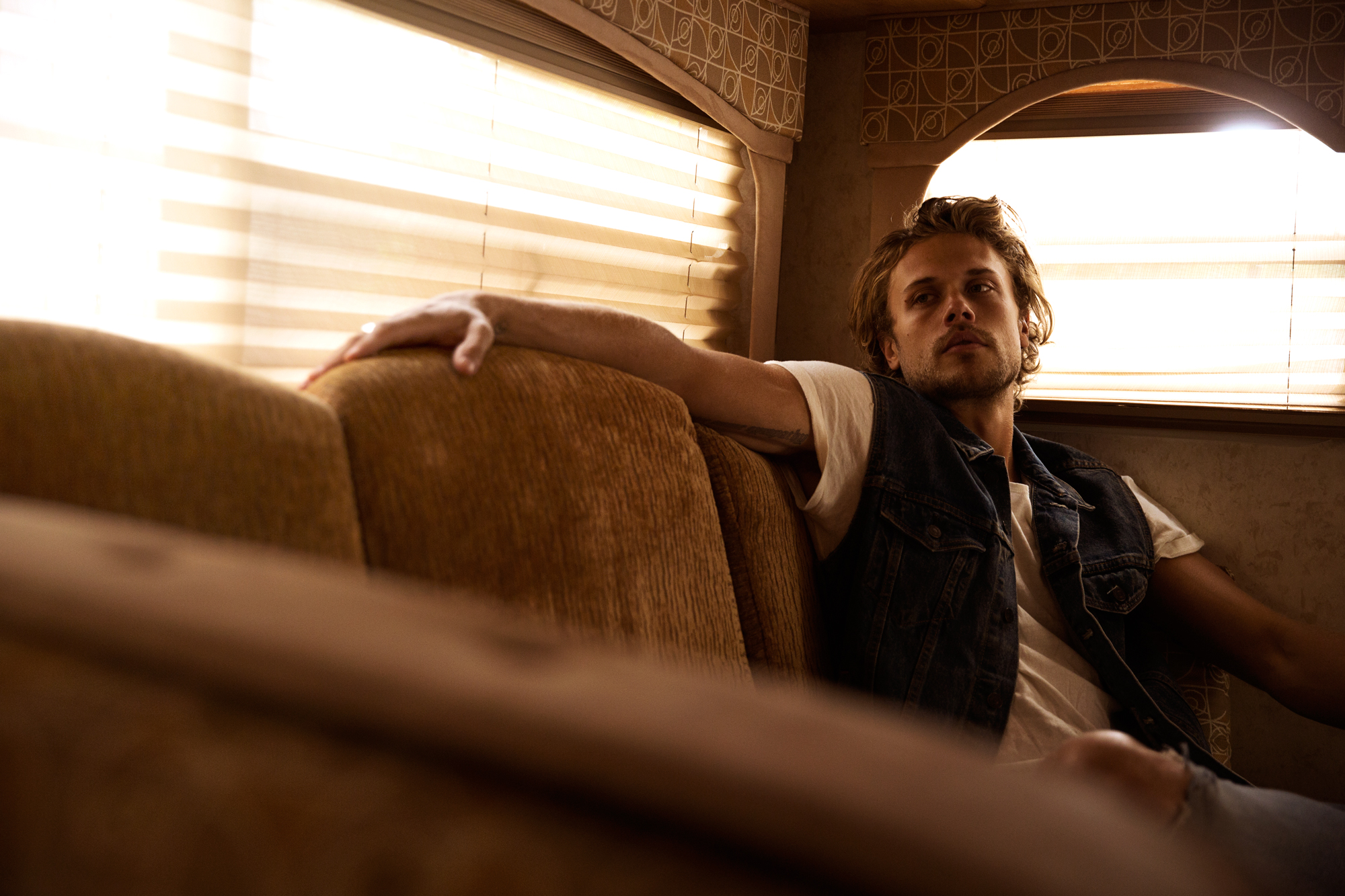 Christopher Mason sitting on a sofa in a trailer in Los Angeles